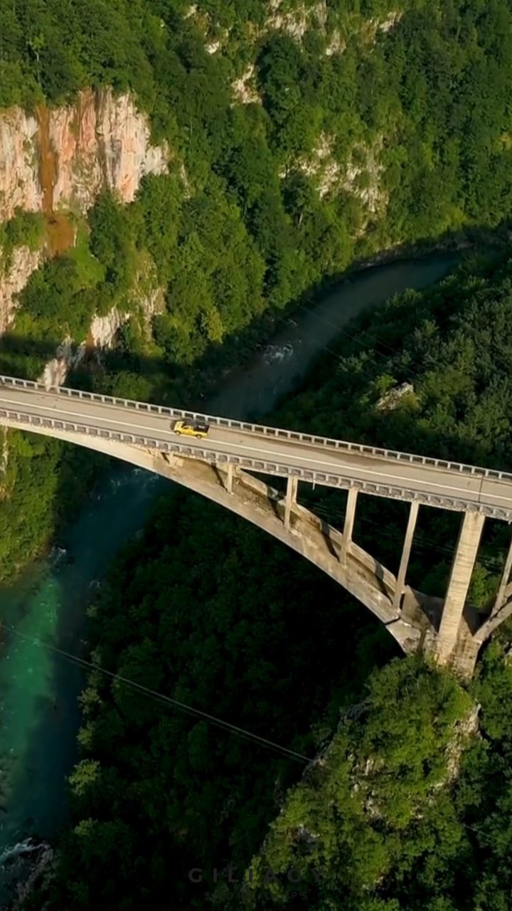 Aerial still of an arch bridge over a river gorge