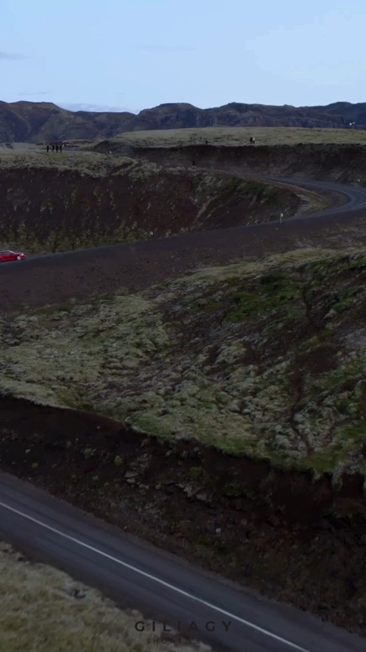 Aerial still of a road cutting through a lava field